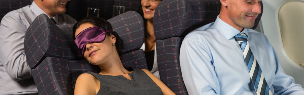 eye masks for travel - woman asleep on plane