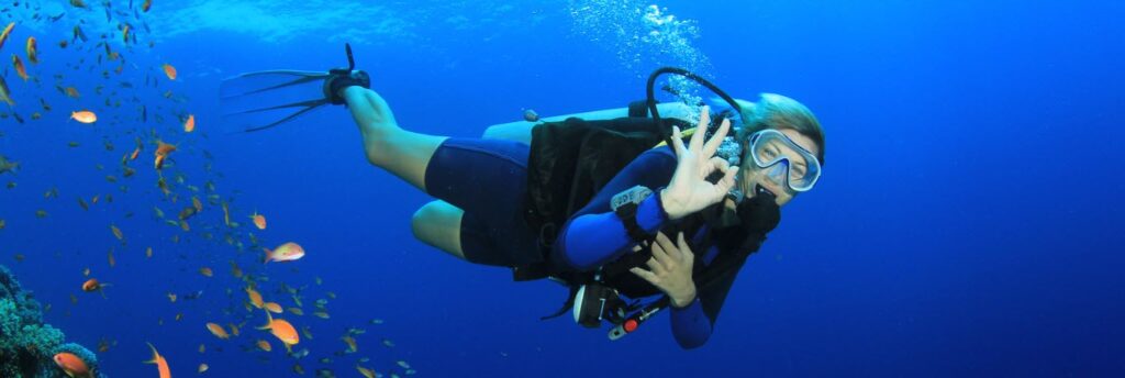 best travel bags for scuba gear - woman scuba diving