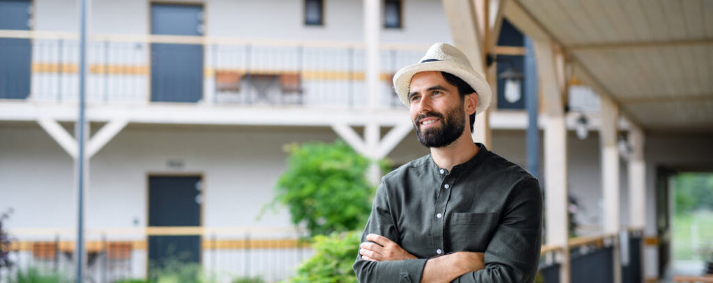 List of Different Accommodation Types for Travel - man on hotel veranda
